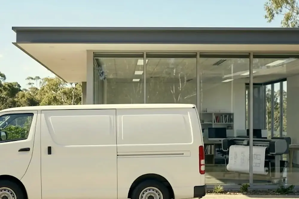 White service van parked outside a modern Brisbane office building